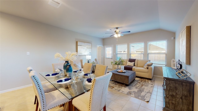 dining room with a ceiling fan, baseboards, visible vents, and lofted ceiling