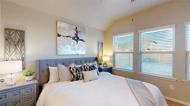 carpeted bedroom featuring baseboards and lofted ceiling