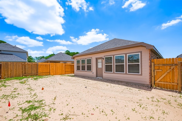 17722 Pamukkale Pl, Tomball, TX 77377 - back of house with a fenced backyard, a gate, and roof with shingles
