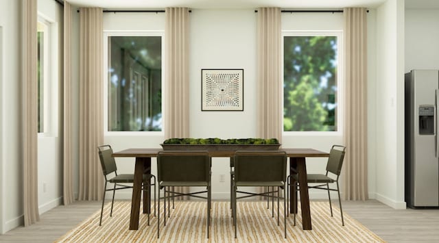 dining room with wood finished floors and baseboards