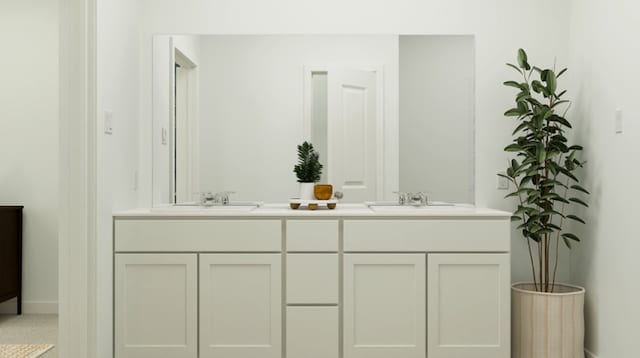 bathroom featuring baseboards, a sink, and double vanity