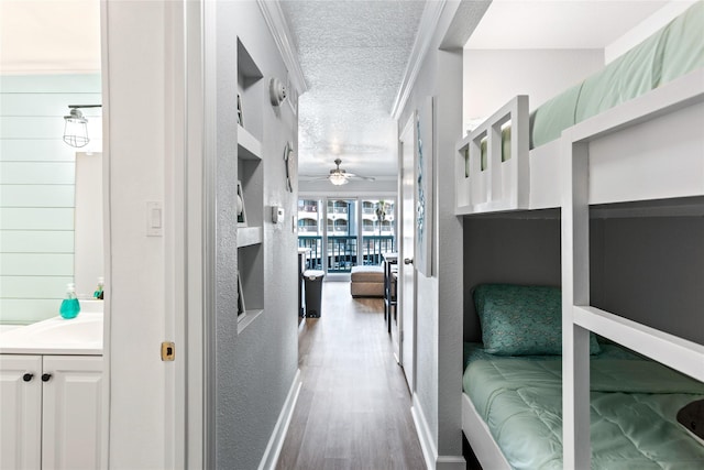 6300 Seawall Blvd Unit 3225, Galveston, TX 77551 - hallway with wood finished floors and a textured ceiling