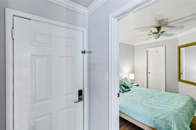 6300 Seawall Blvd Unit 3225, Galveston, TX 77551 - bedroom with a ceiling fan, crown molding, wood finished floors, and a textured ceiling