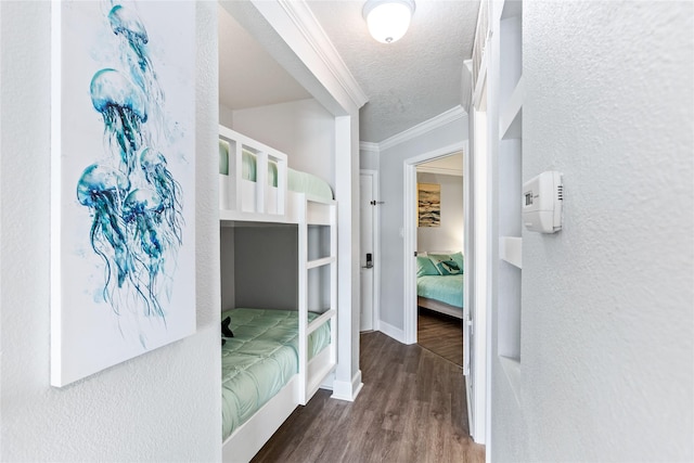 6300 Seawall Blvd Unit 3225, Galveston, TX 77551 - bedroom featuring wood finished floors, a textured ceiling, a textured wall, baseboards, and ornamental molding