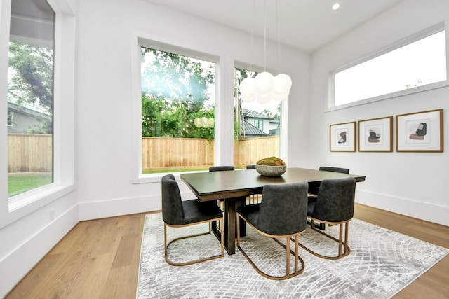 dining space with light wood-style floors, recessed lighting, and baseboards