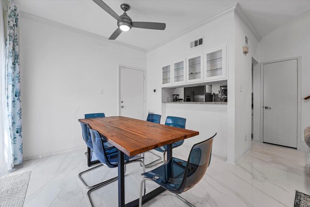 dining area with ornamental molding, visible vents, marble finish floor, and a ceiling fan