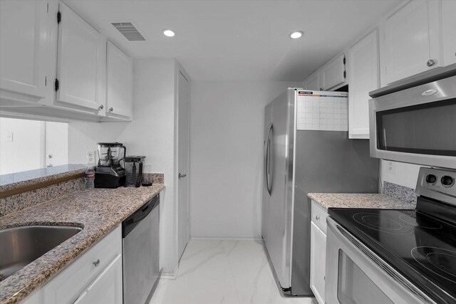kitchen with visible vents, marble finish floor, white cabinets, and appliances with stainless steel finishes