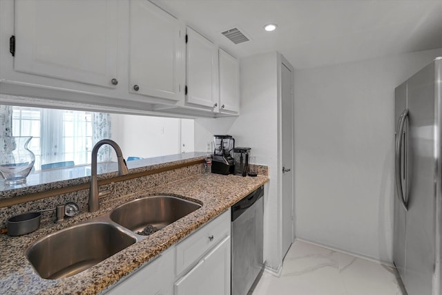 kitchen featuring stainless steel appliances, a sink, visible vents, marble finish floor, and light stone countertops