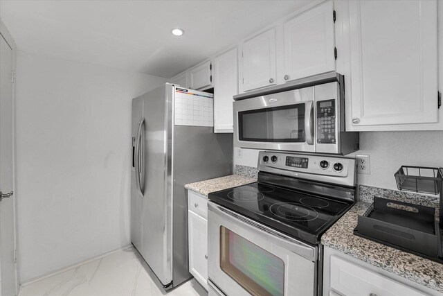 kitchen featuring white cabinets, stainless steel appliances, marble finish floor, and recessed lighting