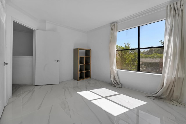spare room featuring marble finish floor