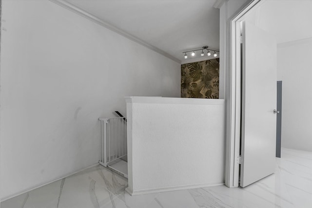 bathroom with baseboards, marble finish floor, and crown molding