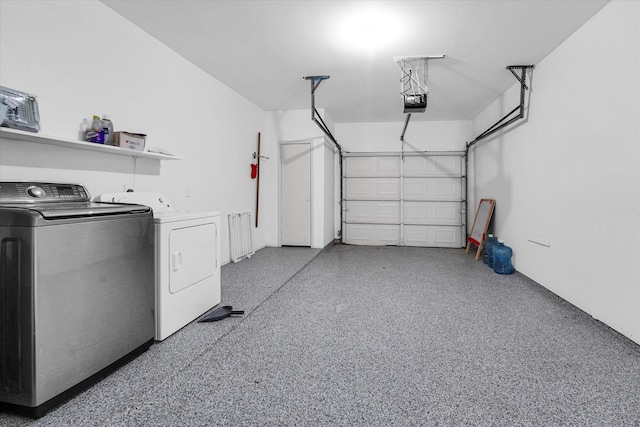 garage with washer and dryer and a garage door opener