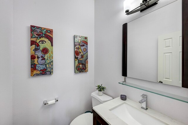 bathroom featuring toilet and vanity