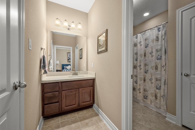 bathroom featuring ensuite bathroom, tile patterned floors, vanity, and a shower with shower curtain