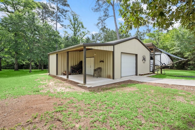 garage with concrete driveway and a detached garage