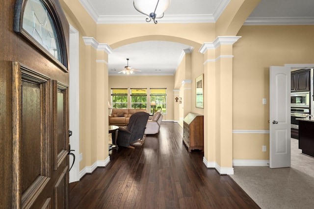 entryway with ceiling fan, arched walkways, ornate columns, and dark wood-type flooring