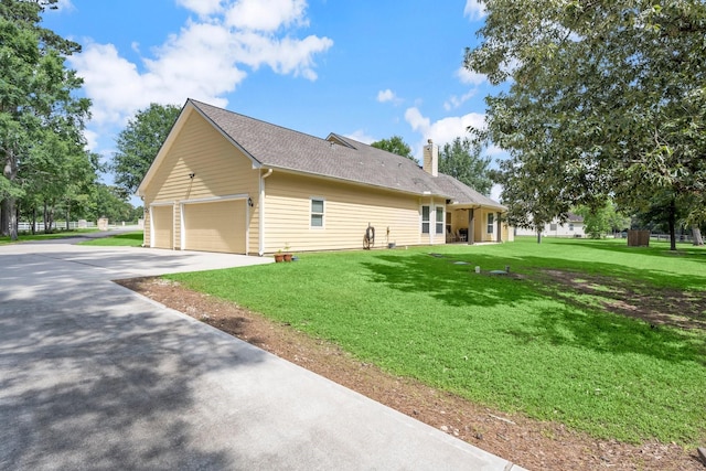 view of property exterior featuring a yard, concrete driveway, and a chimney