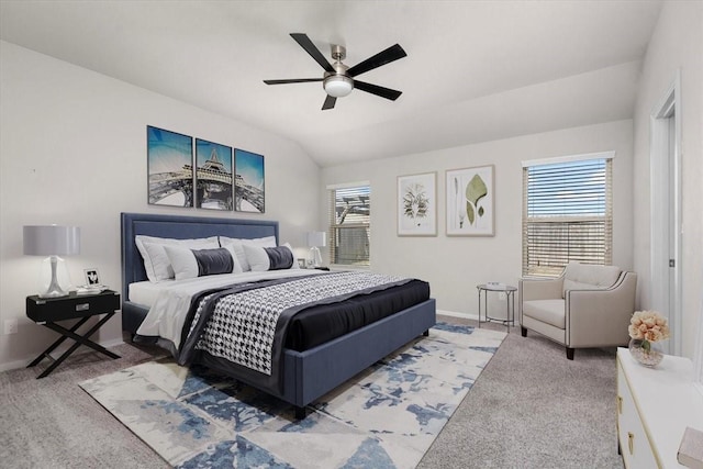 carpeted bedroom with baseboards, a ceiling fan, multiple windows, and lofted ceiling