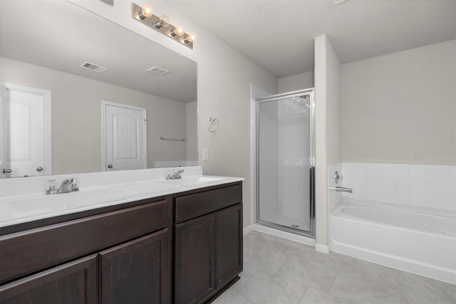 bathroom with tile patterned floors, a sink, double vanity, a stall shower, and visible vents