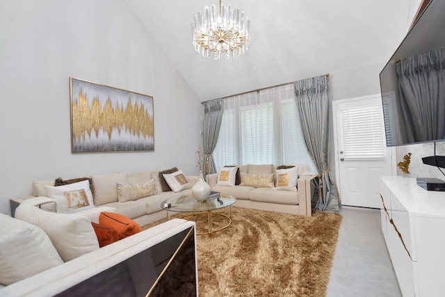 living area featuring high vaulted ceiling, an inviting chandelier, and plenty of natural light