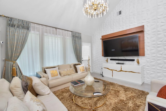 living room with lofted ceiling, visible vents, and an inviting chandelier