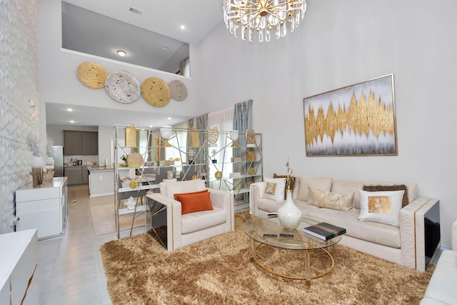 living room with an inviting chandelier, light tile patterned flooring, a towering ceiling, and visible vents