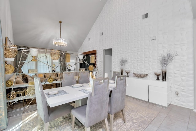 dining area with light tile patterned flooring, visible vents, an inviting chandelier, wallpapered walls, and high vaulted ceiling
