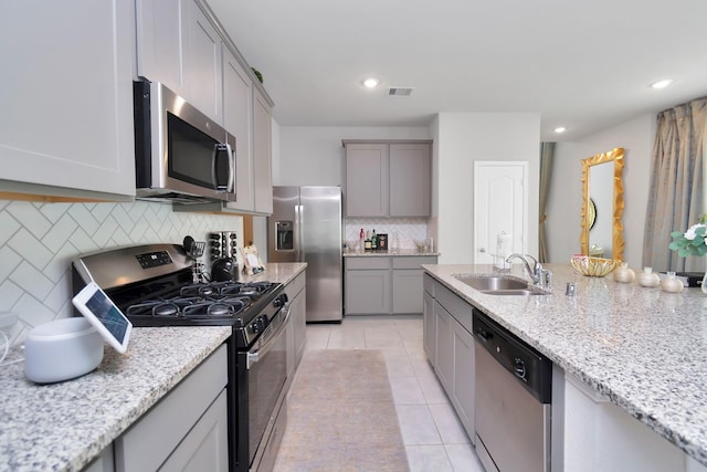 kitchen featuring a sink, visible vents, appliances with stainless steel finishes, gray cabinets, and light tile patterned floors