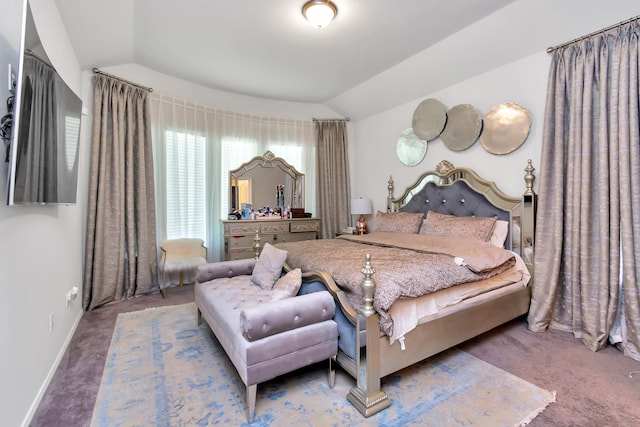 bedroom with vaulted ceiling, baseboards, and carpet flooring