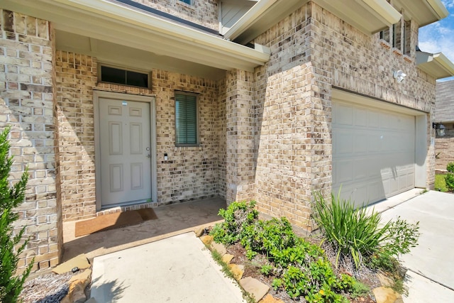 property entrance with brick siding and concrete driveway
