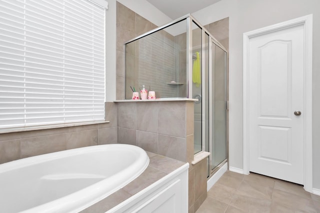 full bathroom with a garden tub, tile patterned flooring, and a stall shower
