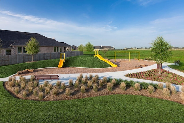 community playground featuring fence and a yard