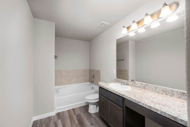 304 N Orange St, Sweeny, TX 77480 - bathroom with a bath, wood finished floors, vanity, and toilet