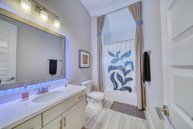 full bathroom featuring toilet, shower / bath combination with curtain, and vanity