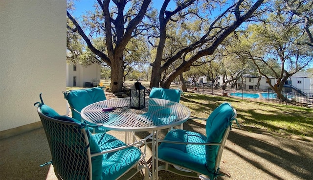 view of patio featuring outdoor dining area and fence