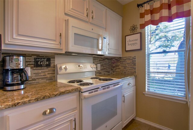 kitchen with white cabinets, decorative backsplash, and white appliances