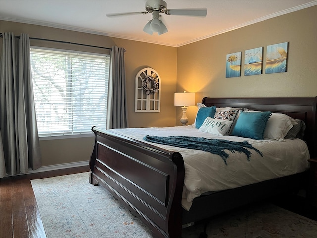 bedroom with ceiling fan, baseboards, wood finished floors, and ornamental molding