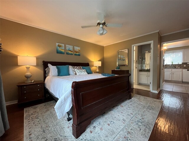 bedroom with wood finished floors, a ceiling fan, ensuite bath, crown molding, and baseboards