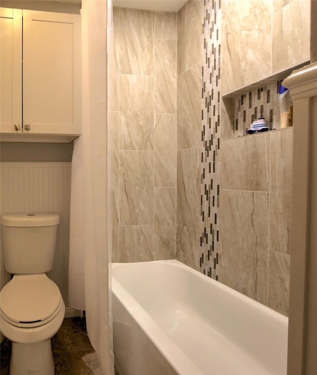 bathroom featuring shower / bath combination with curtain and toilet