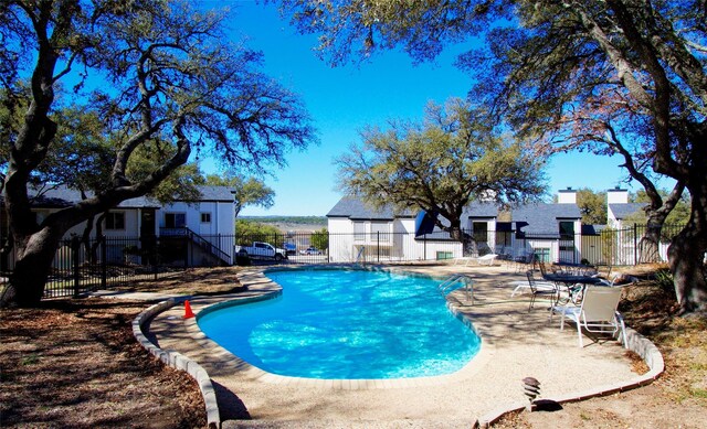 pool with fence and a patio