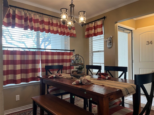 dining space featuring ornamental molding and an inviting chandelier