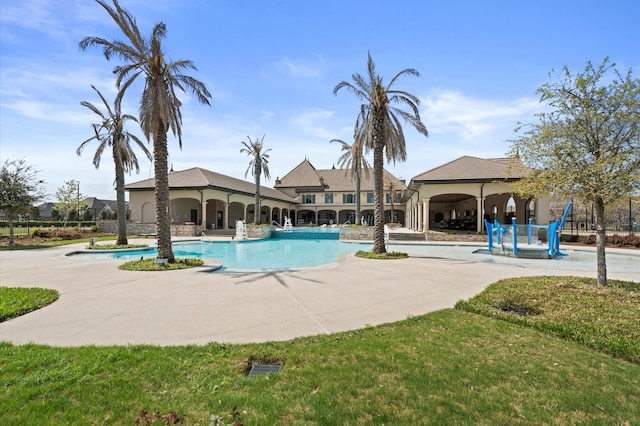 community pool with a gazebo and a patio