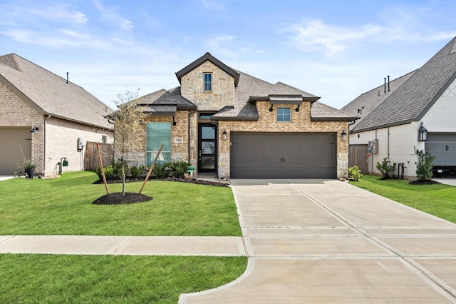 20806 Gray Percheron Ln, Tomball, TX 77377 - french provincial home with driveway, brick siding, stone siding, a shingled roof, and a garage