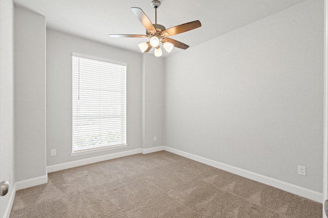 empty room with a ceiling fan, baseboards, and carpet floors