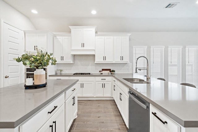 20806 Gray Percheron Ln, Tomball, TX 77377 - kitchen with stainless steel dishwasher, decorative backsplash, white cabinetry, a peninsula, and a center island