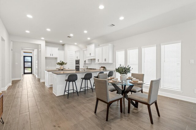 20806 Gray Percheron Ln, Tomball, TX 77377 - dining space with wood finished floors and recessed lighting