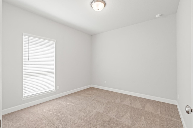 carpeted empty room with baseboards