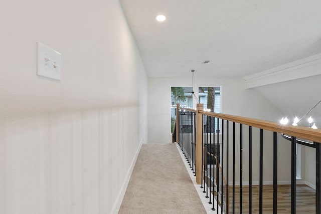 corridor with recessed lighting, baseboards, and an upstairs landing