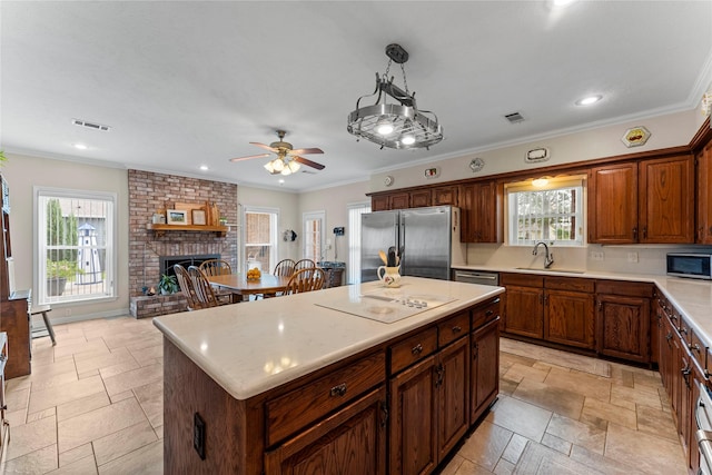 466 Buffalo Ct, Livingston, TX 77351 - kitchen featuring light countertops, a healthy amount of sunlight, appliances with stainless steel finishes, and a sink