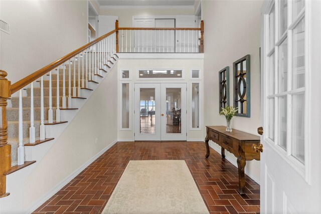 466 Buffalo Ct, Livingston, TX 77351 - foyer featuring brick floor, stairway, baseboards, and french doors